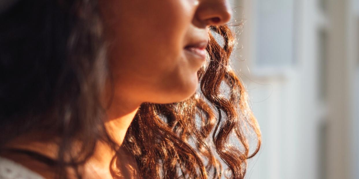 close up of woman looking out window - stopped being a people pleaser