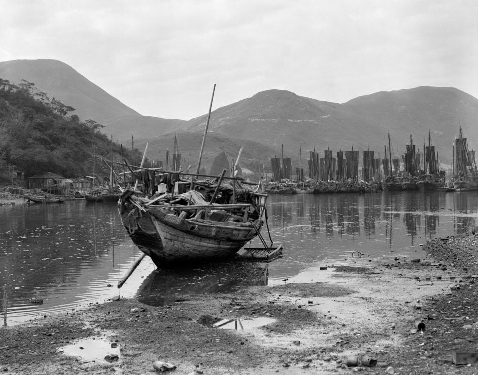 A traditional junk boat sitting on its keel at low tide in Aberdeen Harbor.