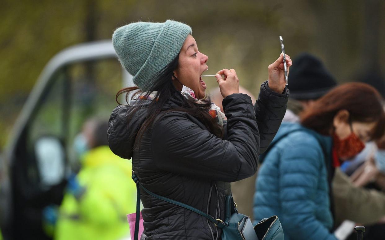 People take part in coronavirus surge testing on Clapham Common, south London. Thousands of residents have queued up to take coronavirus tests at additional facilities set up after new cases of the South African variant were found in two south London boroughs. 44 confirmed cases of the variant have been found in Lambeth and Wandsworth, with a further 30 probable cases identified. Picture date: Wednesday April 14, 2021. PA Photo. See PA story HEALTH Coronavirus.  - Kirsty O'Connor/PA Wire