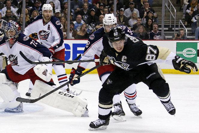 Pittsburgh Penguins' Sidney Crosby (87) goes after the puck in front of Columbus Blue Jackets goalie Sergei Bobrovsky (72), and David Savard in the second period of Game 5 of a first-round NHL playoff hockey series in Pittsburgh, Saturday, April 26, 2014. (AP Photo/Gene J. Puskar)