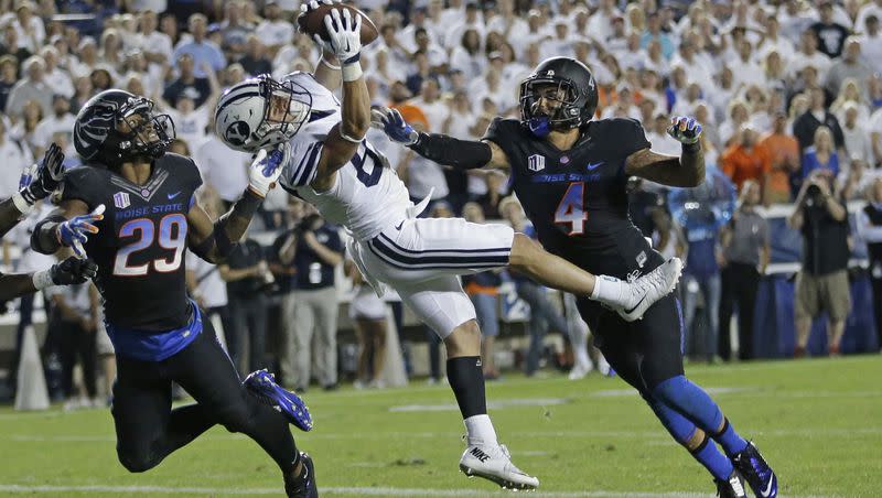 BYU wide receiver Mitchell Juergens catches the go-ahead touchdown as Boise State’s Dylan Sumner-Gardner (29) and Darian Thompson defend Saturday, Sept. 12, 2015, in Provo, Utah. BYU won 35-24.