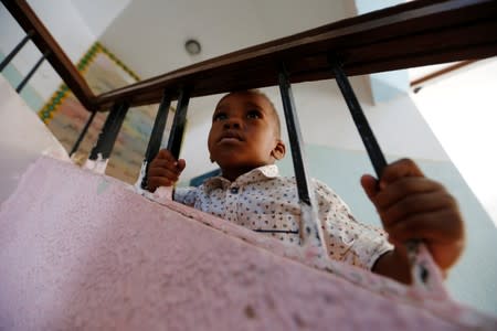 A displaced child who left his home with his family after clashes is seen at a school used as a shelter in Abu Slim district in Tripoli