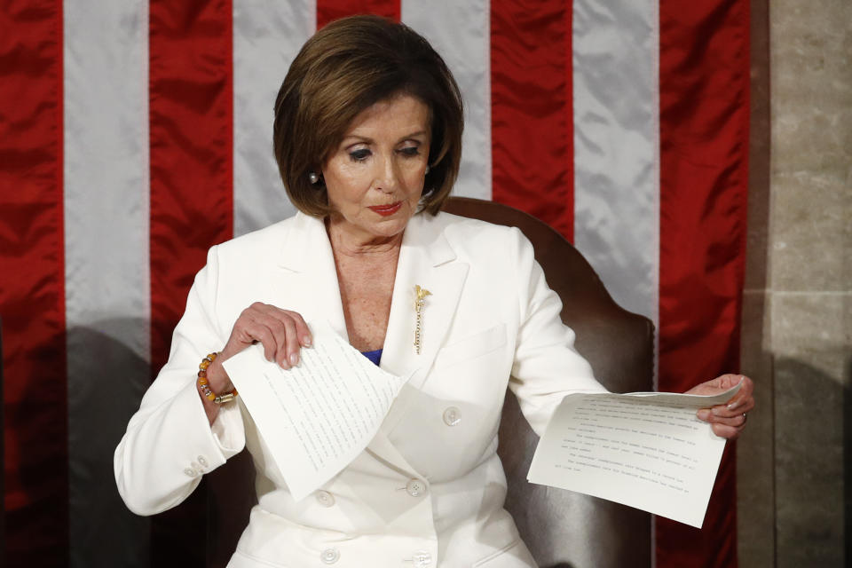 FILE - House Speaker Nancy Pelosi of California, tears her copy of President Donald Trump's State of the Union address after he delivered it to a joint session of Congress on Capitol Hill in Washington, on Feb. 4, 2020. Pelosi's decision to step down from Democratic leadership after 20 years has many women admiring the way she wielded power. (AP Photo/Patrick Semansky, File)