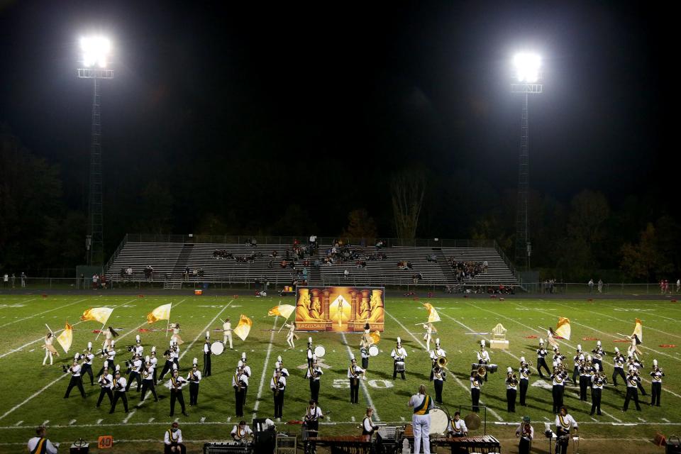 The Dover High School band and color guard perform at halftime at a Portsmouth High School Football game.