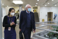 Sen. Bernie Sanders, I-Vt., chair of the Senate Budget Committee, returns to his office while the Senate continues work on the Democrats' $1.9 trillion COVID-19 relief bill, in Washington, Friday, March 5, 2021. Senators plan to continue to vote on amendments through the night. (AP Photo/J. Scott Applewhite)