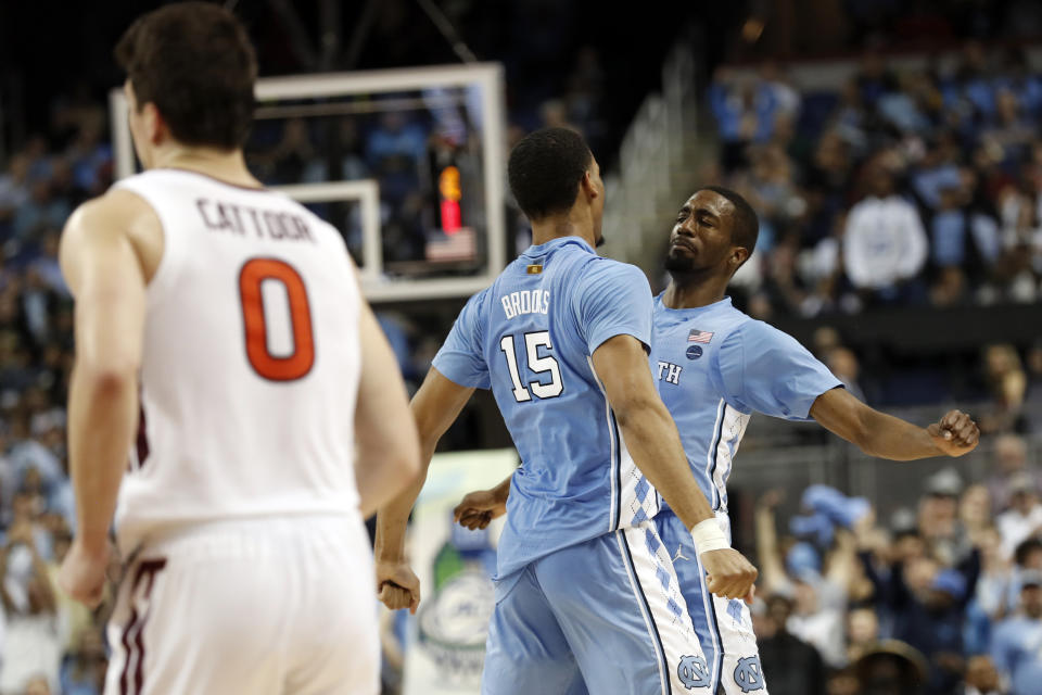North Carolina forward Garrison Brooks (15) and guard Brandon Robinson (4) react during the second half of an NCAA college basketball game against Virginia Tech at the Atlantic Coast Conference tournament in Greensboro, N.C., Tuesday, March 10, 2020. (AP Photo/Gerry Broome)