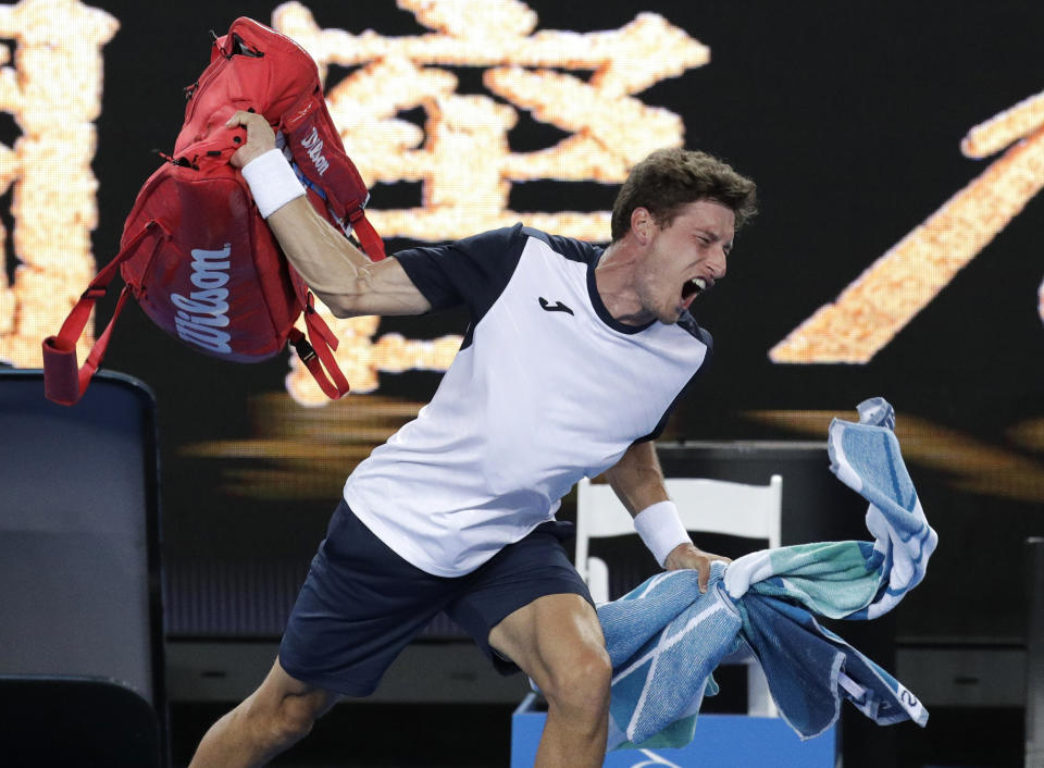 Spain’s Pablo Carreno Busta throws his bag in frustration after losing his fourth-round match to Japan’s Kei Nishikori at the Australian Open on Monday. (AP/Aaron Favila)