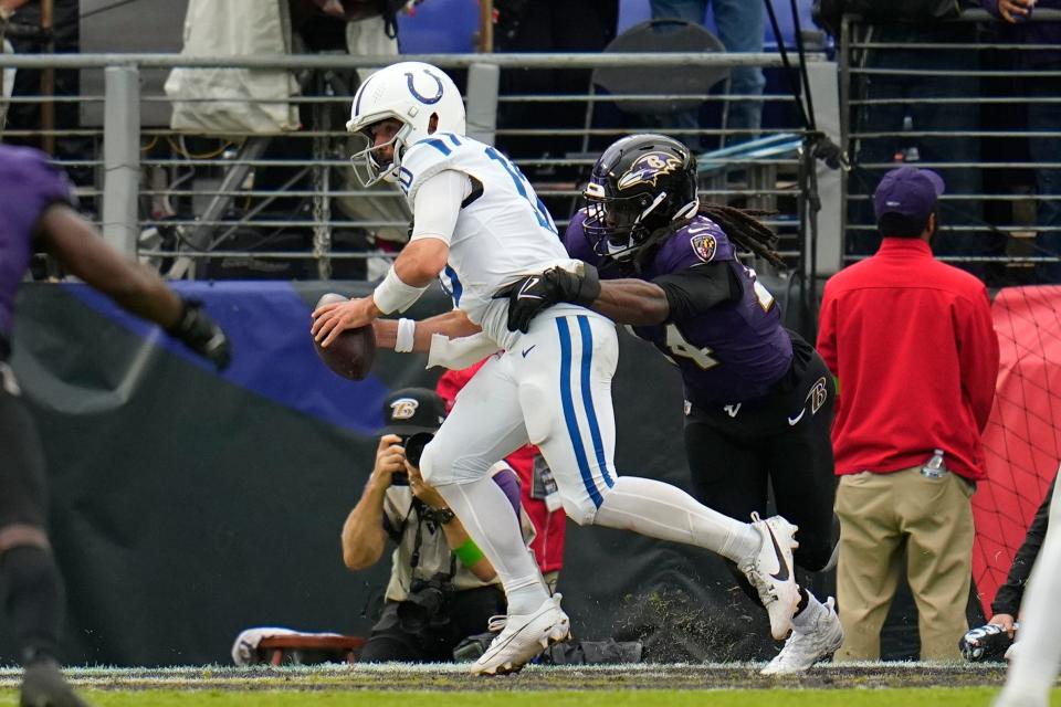 Baltimore Ravens' Jadeveon Clowney (24) hits Indianapolis Colts quarterback Gardner Minshew (10) in the end zone for a safety during the second half of an NFL football game, Sunday, Sept. 24, 2023, in Baltimore. (AP Photo/Julio Cortez)