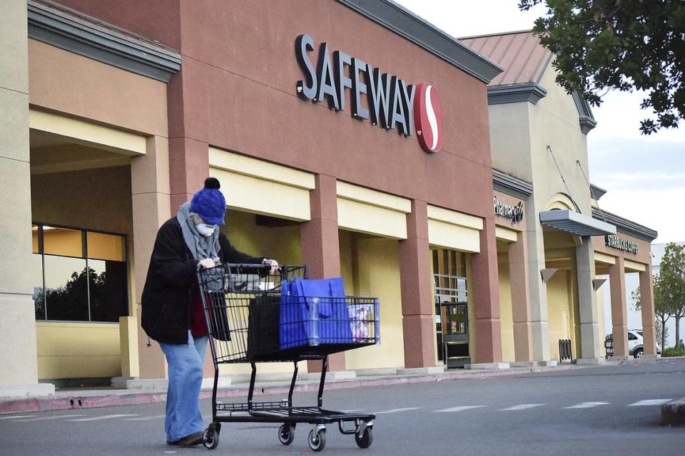 A woman walks out of Safeway Modesto in 2020.