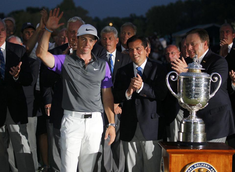 Rory McIlroy of Northern Ireland celebrates with PGA officials when presented with the Wanamaker Trophy after winning the 2014 PGA Championship at Valhalla Golf Club in Louisville