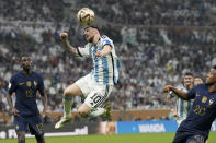 FILE - Argentina's Lionel Messi heads the ball next to France's Kingsley Coman, right, during the World Cup final soccer match between Argentina and France at the Lusail Stadium in Lusail, Qatar, Sunday, Dec. 18, 2022. Lionel Messi says he is coming to Inter Miami and joining Major League Soccer. After months of speculation, Messi announced his decision Wednesday, June 7, 2023,to join a Miami franchise that has been led by another global soccer icon in David Beckham since its inception but has yet to make any real splashes on the field. (AP Photo/Martin Meissner, File)