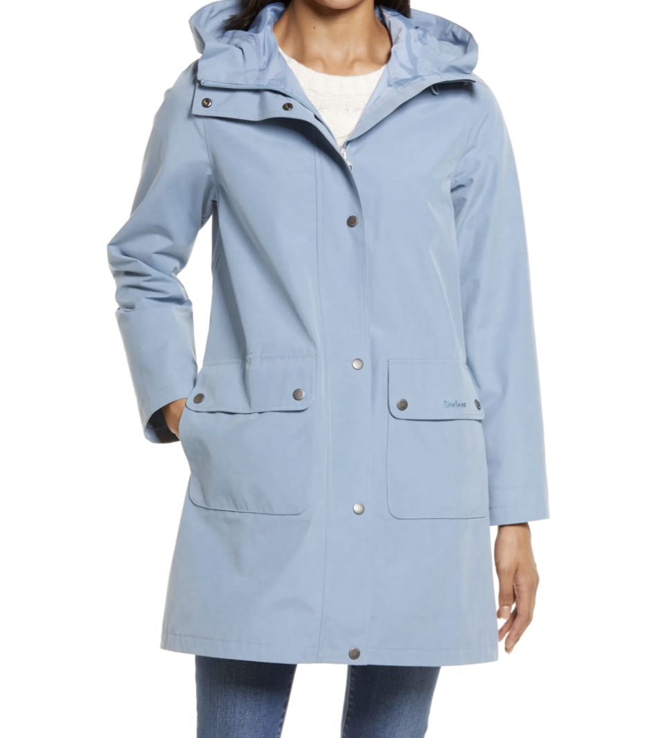 model wearing light blue Barbour Ashover Waterproof Hooded Raincoat and skinny jeans