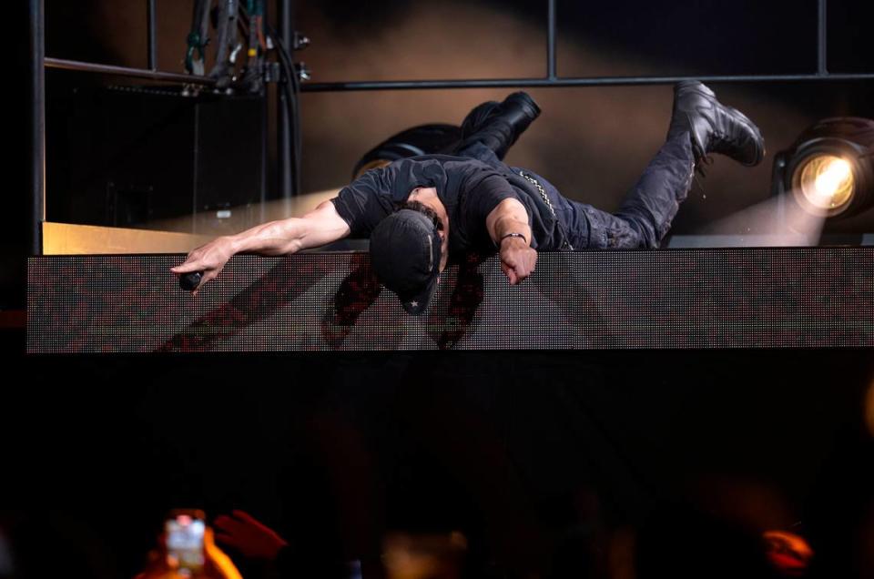 Enrique Iglesias goes prone on a riser on “The Trilogy Tour” at Raleigh, N.C.’s PNC Arena, Thursday night, Feb. 29, 2024.