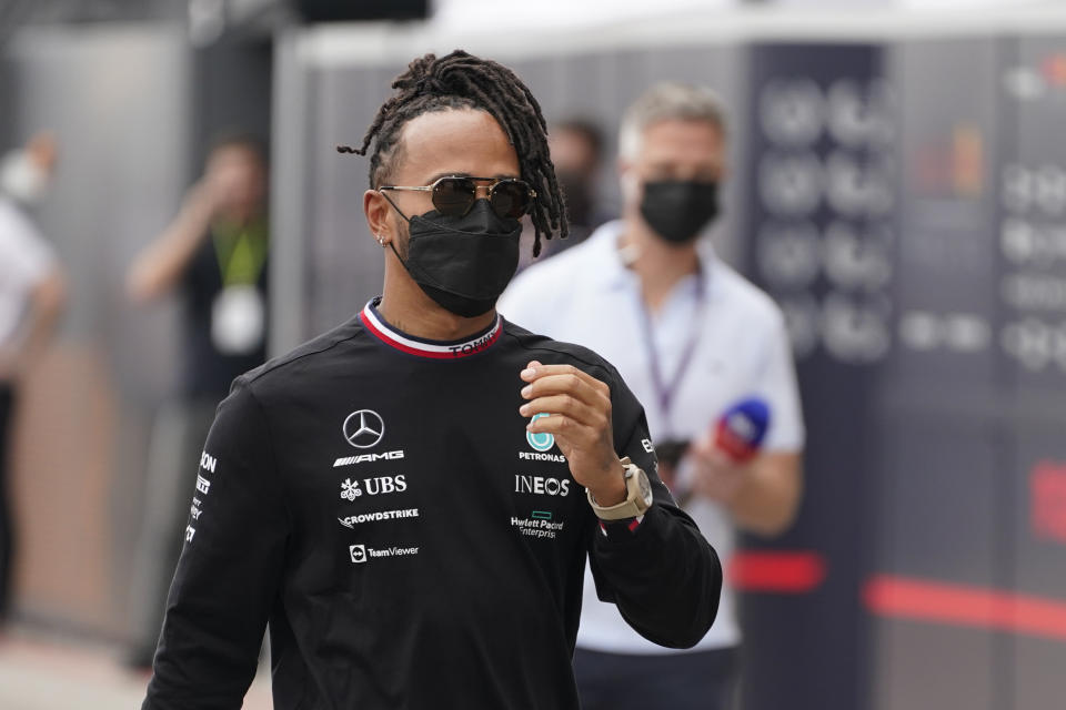 Mercedes driver Lewis Hamilton, of Britain, walks to a news conference before the Formula One U.S. Grand Prix auto race at the Circuit of the Americas, Thursday, Oct. 21, 2021, in Austin, Texas. (AP Photo/Darron Cummings)