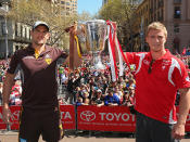 Captains Luke Hodge of Hatwhorn and Kieren Jack of Sydney hold aloft the AFL trophy.