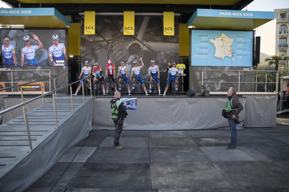 Deceuninck - Quick - Step's Zdenek Stybar, of The Czech Republic, waves as his team is presented to an empty venue in Nice, southern France, before the start of the seventh stage of the Paris Nice cycling race. The eighth and final stage of the event was cancelled and spectators are prevented from attending the race due to measures in place to prevent the spread of the Covid-19 virus. For most people, the new coronavirus causes only mild or moderate symptoms. For some it can cause more severe illness. Stage seven runs just over 166 kilometers starting in Nice and finishing in Valdeblore La Colmiane, France, Saturday, March 14, 2020. (AP Photo/Daniel Cole)