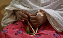 Nazima Shaikh, mother of Arbaz Mullah holds prayer beads as she prays at her home, in Belagavi, India, Oct. 7, 2021. Arbaz Mullah was a Muslim man in love with a Hindu woman. But the romance so angered the woman’s family that — according to police — they hired members of a hard-line Hindu group to murder him. It's a grim illustration of the risks facing interfaith couples as Hindu nationalism surges in India. (AP Photo/Aijaz Rahi)