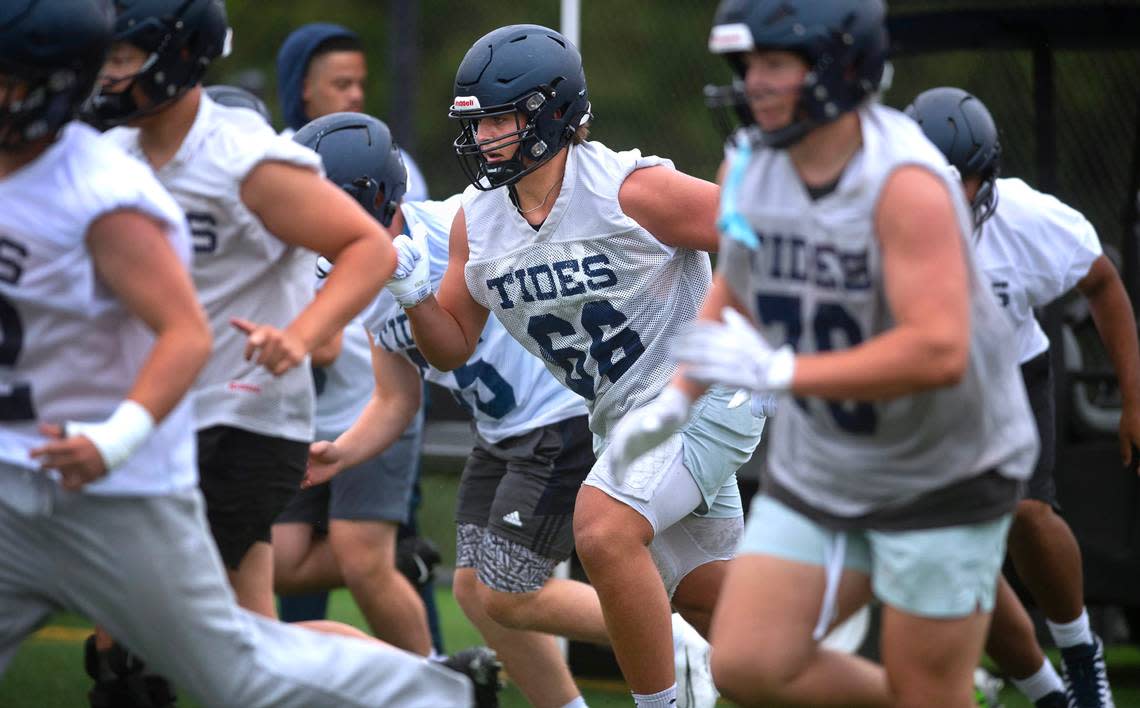 Gig Harbor lineman Peyton Howard (66) and his Tide teammates run through drills during preseason football practice at Gig Harbor High School in Gig Harbor, Washington, on Friday, Aug. 23, 2024.