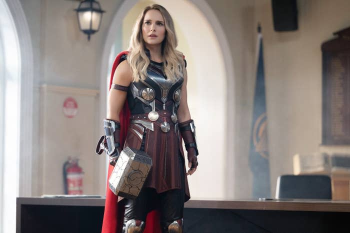 Natalie Portman in her Thor costume and carrying Thor's hammer