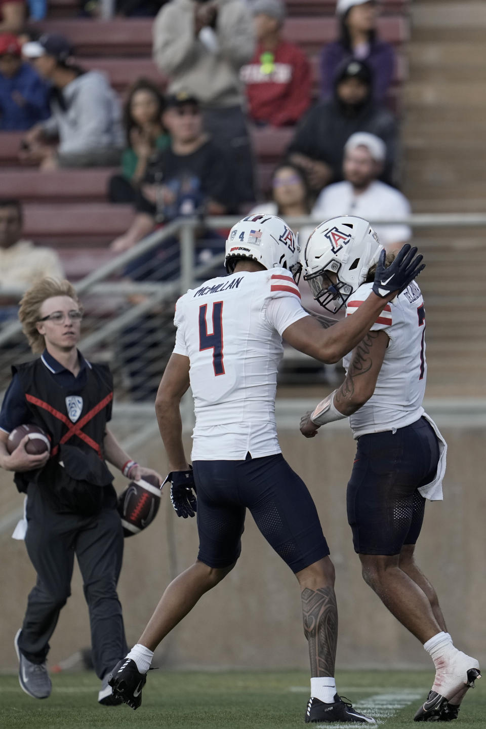 Arizona quarterback Jayden de Laura, right, celebrates with wide receiver Tetairoa McMillan (4) after scoring a rushing touchdown against Stanford during the second half of an NCAA college football game Saturday, Sept. 23, 2023, in Stanford, Calif. (AP Photo/Godofredo A. Vásquez)