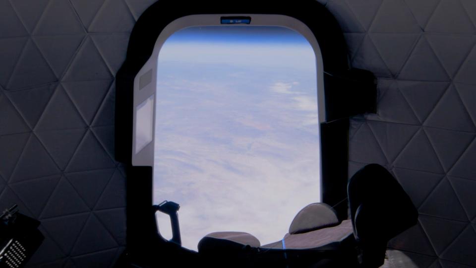 blue origin new shepard crew capsule view from spaceship window in space