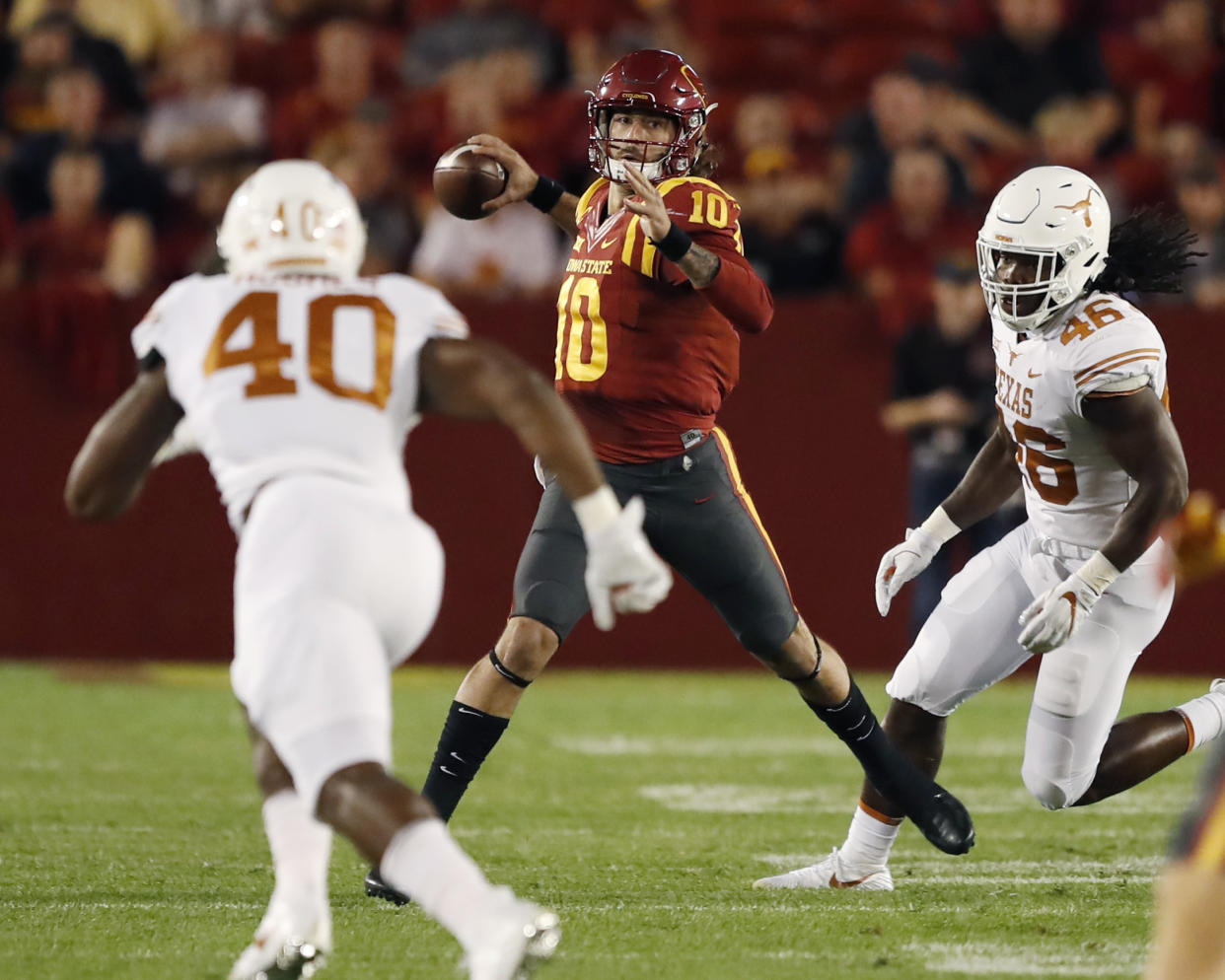 Iowa State quarterback Jacob Park (10) looks to throw past Texas defenders Naashon Hughes (40) and Malik Jefferson (46) during the first half of an NCAA college football game, Thursday, Sept. 28, 2017, in Ames, Iowa. (AP Photo/Charlie Neibergall)