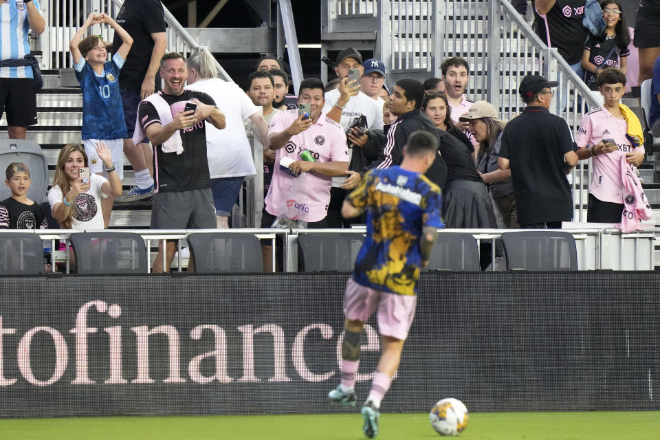 Fans watch as Inter Miami forward Lionel Messi warms up before the start of an MLS soccer match against Toronto FC, Wednesday, Sept. 20, 2023, in Fort Lauderdale, Fla. Messi has set a new standard for the league as excitement builds for the 2026 World Cup, co-hosted by the United States, Mexico and Canada. (AP Photo/Wilfredo Lee)