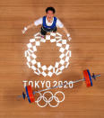 <p>Myeongmok Han of South Korea competes during the weightlifting - men's 67kg group A on July 25. </p>