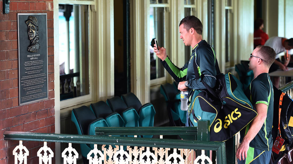 Peter Siddle, pictured here inspecting a plaque remembering the late Phillip Hughes at the SCG in 2015.