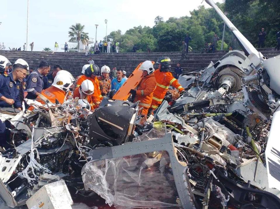 Malaysia fire and rescue department inspect the crash site of two helicopter in Lumur, Perak state (AP)