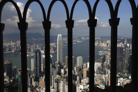 The skyline of Hong Kong is seen through a fence at the Peak in Hong Kong in this September 10, 2014 file photo. REUTERS/Bobby Yip/Files