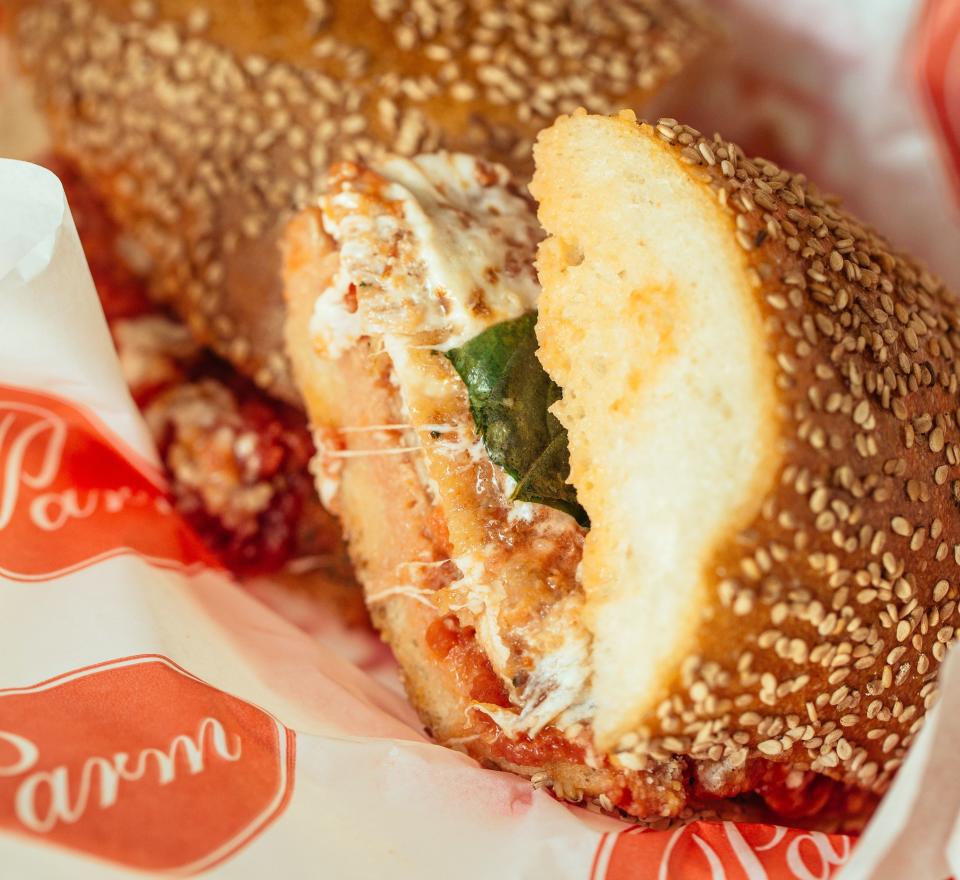 The chicken parm sandwich from Parm is a breaded, enormous hunk of chicken covered in overflowing, melty mozz and red sauce. (Photo: Parm)