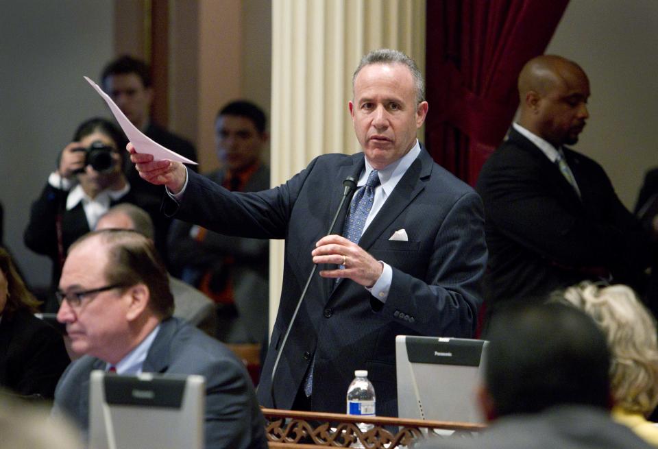 California Senate President Pro Tem Darrell Steinberg, D-Sacramento, introduces a resolution to suspend three Democrats who face charges in criminal cases on the floor of the Senate in Sacramento, Calif., on Friday, March 28, 2014. The resolution, which passed 28-1, prevents Democratic Sens. Ron Calderon, Leland Yee and Rod Wright from exercising any power of their office until the pending criminal cases against them have been resolved.(AP Photo/Steve Yeater)