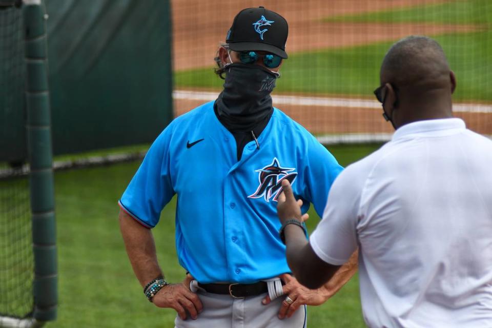 Miami Marlins manager Don Mattingly talks with Michael Hill, former Marlins president of baseball operations and current MLB senior vice president of on-field operations, on Saturday, Feb. 27, 2021, at Roger Dean Chevrolet Stadium in Jupiter, Florida.
