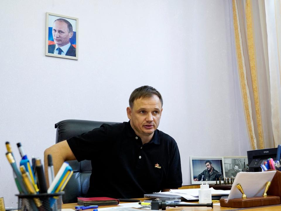 Kirill Stremousov, deputy head of the Russian-backed Kherson administration, is pictured in his office, with a portrait of Russian President Vladimir Putin seen on the wall behind him, in the city of Kherson on July 20, 2022, amid the ongoing Russian military action in Ukraine.