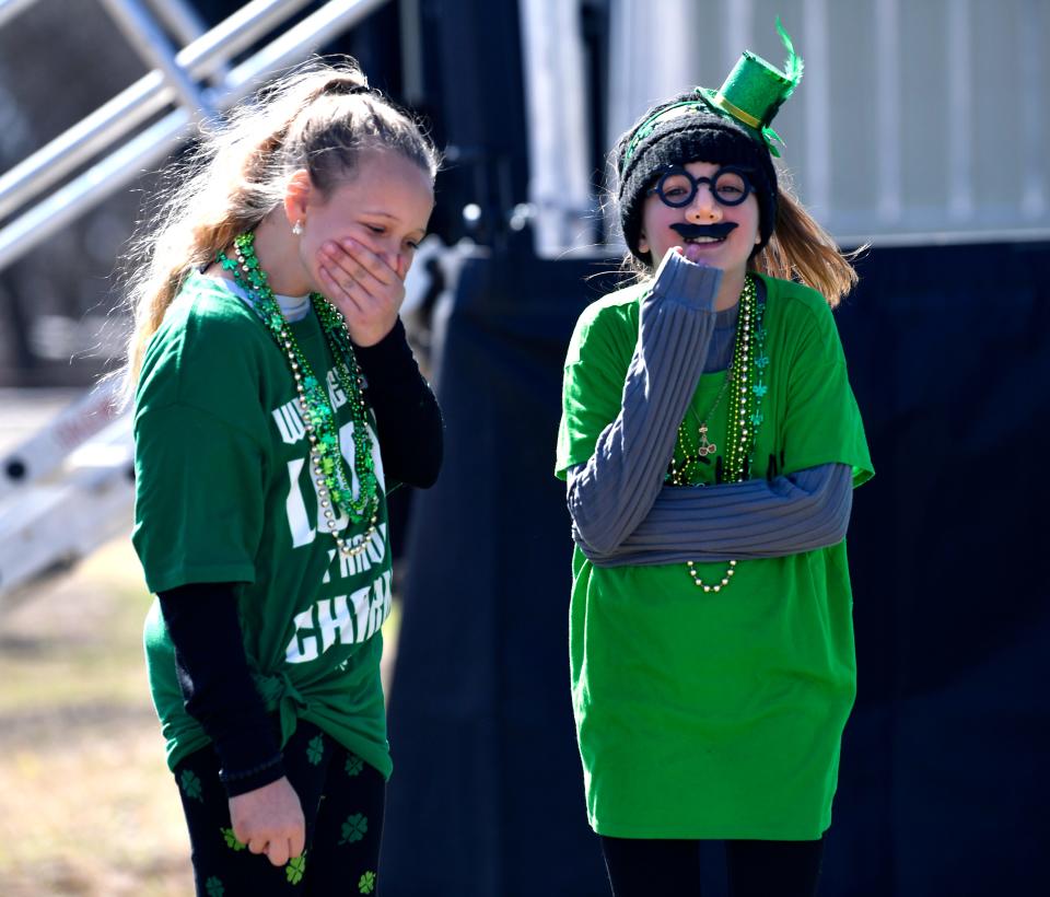 Tucker Parkinson (left) and Hensley Hill, both 11 and from Haslet, share a laugh during the Irish costume contest as Saturday's St. Patrick's Festival in Dublin March 12, 2022.