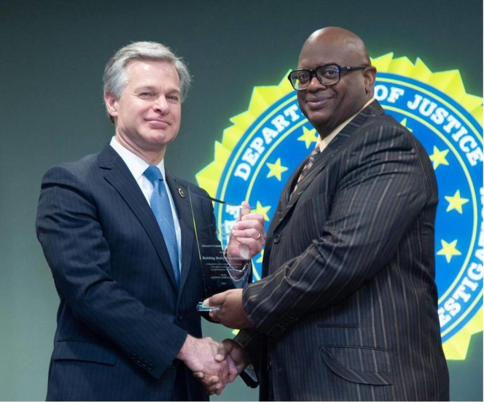 Perry Bradley accepts the the Director’s Community Leadership Award from FBI Director Christopher Wray on May 5, 2023.
