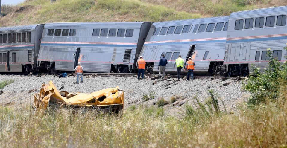 Derailed cars of an Amtrak Coast Starlight train lean after the train struck a water truck in Moorpark on Wednesday. About 15 passengers were taken to local hospitals with minor injuries, while the truck driver was taken to a trauma center with serious injuries.