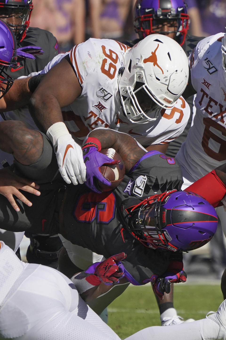 Texas defensive lineman Keondre Coburn (99) tackles TCU running back Darius Anderson (6) in the first half of an NCAA college football game in Fort Worth, Texas, Saturday, Oct. 26, 2019. (AP Photo/Louis DeLuca)