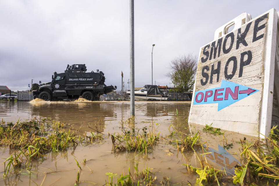 An armored SWAT vehicle drives through floodwaters in Watsonville, Calif., Saturday, March 11, 2023. (AP Photo/Nic Coury)