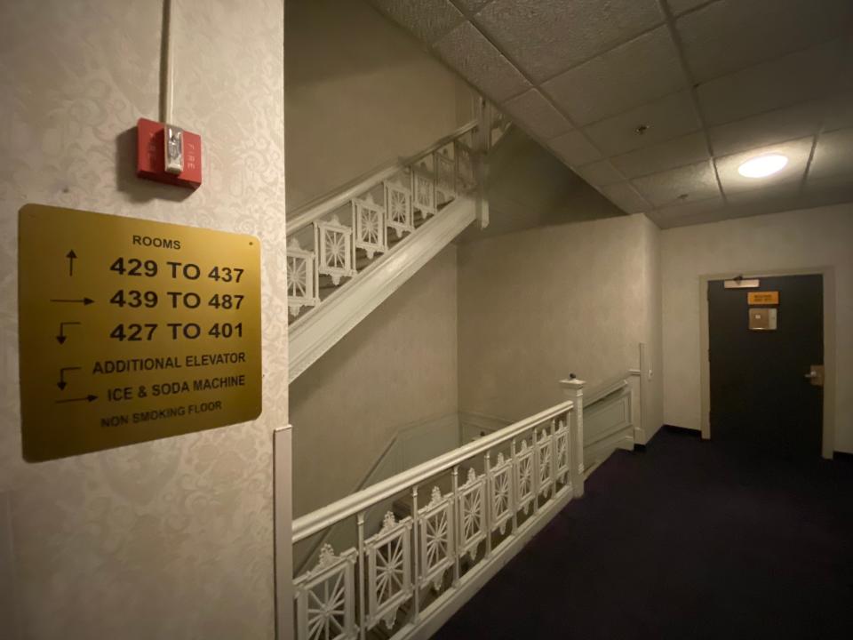 a hotel room sign with staircase in background at congress plaza hotel
