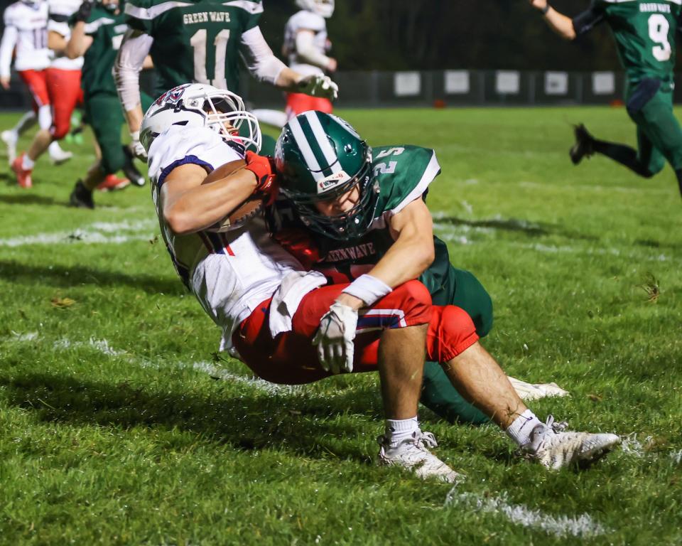 Dover's Brady McInnes makes a tackle on a Memorial runner during Friday's Division I football game.