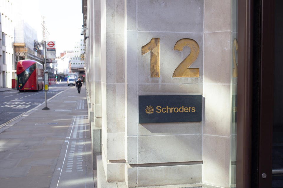 London traffic passing the financial area of London and offices of Schroder’s PLC. A British multinational asset management company