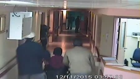 Israeli undercover forces are seen in this still image, taken from Al-Ahli hospital CCTV and obtained by Reuters TV, as they are pushing a wounded Palestinian that they have detained on a wheelchair (C) during a raid into the hospital in the West Bank city of Hebron November 12, 2015. REUTERS/Hebron Al-Ahli Hospital Handout via Reuters TV