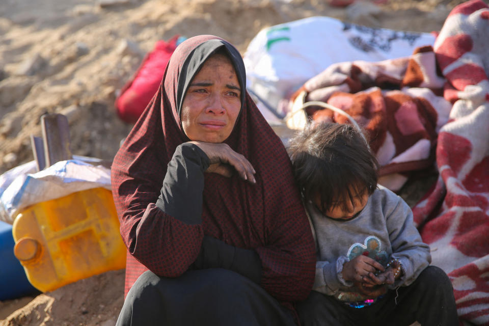 A Palestinian woman and a child sit amid the rubble of Gaza's Shifa Hospital after the Israeli military withdrew from the complex housing the hospital on April 1. 