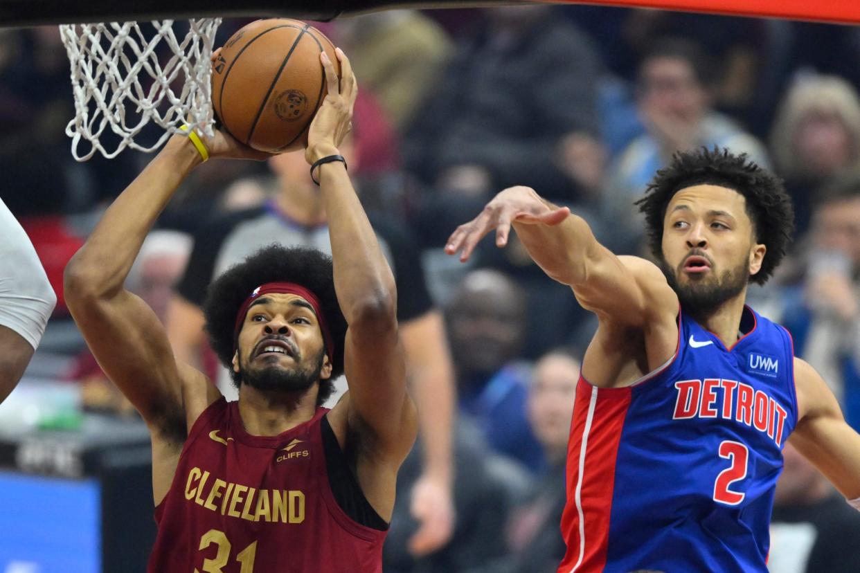 Cavaliers center Jarrett Allen shoots against Pistons guard Cade Cunningham in the first quarter on Wednesday, Jan. 31, 2024, in Cleveland.