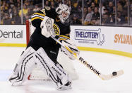 BOSTON, MA - JANUARY 31: Tim Thomas #30 of the Boston Bruins clears the puck in the second period against the Ottawa Senators on January 31, 2012 at TD Garden in Boston, Massachusetts. (Photo by Elsa/Getty Images)