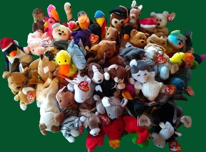 a pile of beanie babies on a green table top