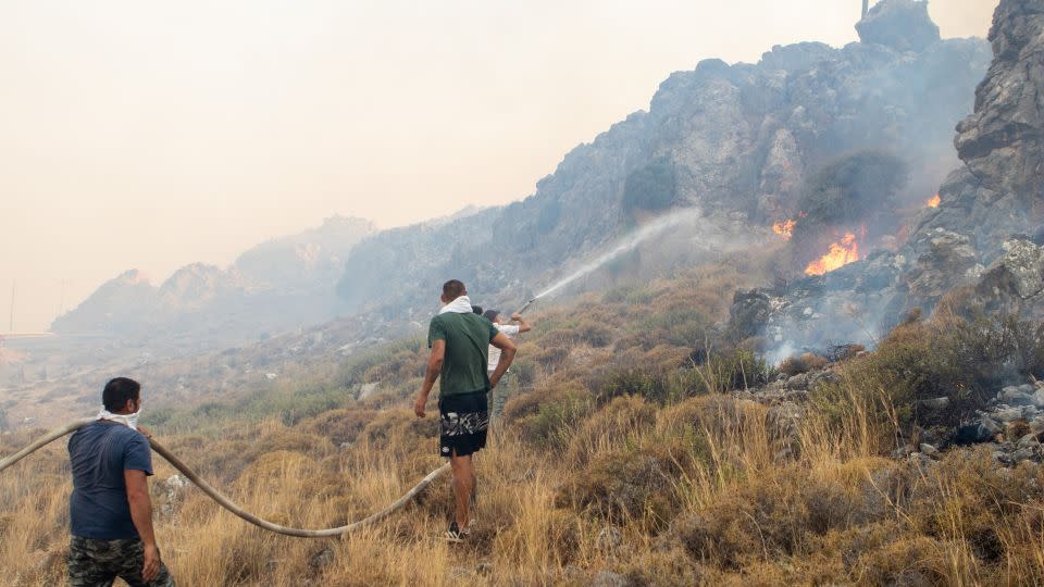 Firefighter teams intervene a wildfire across Greece's Rhodes island on July 22, 2023, as Greece grapples with a severe heat wave.  - Lefty Damian/Anadolu Agency/Getty Images