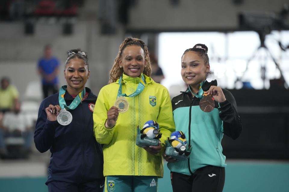 Medalists, from left, The United States´ Jordan Chiles, silver, Brazil's Rebeca Andrade, gold, and Mexico's Natalia Escalera, bronze, show their women's gymnastics vault exercise medals at the Pan American Games in Santiago, Chile, Tuesday, Oct. 24, 2023. (AP Photo/Martin Mejia)